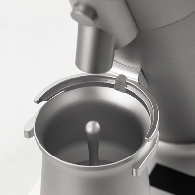Close-up of the WPM ZP1 Single Dose Grinder's magnetic dosing cup and grind collar.